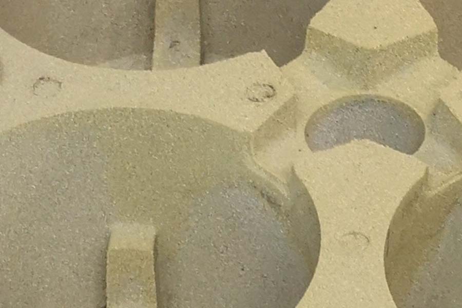 belagt sandform til støbning